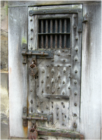 Image: Warick Gaol.  Cell door with massive bolts and locks